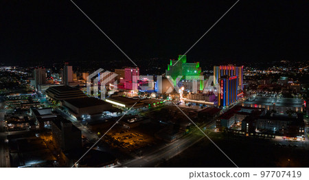 Aerial view of the skyline of Reno Nevada USA at night. City lights, night streets and casinos in Reno, USA. Aerial view of the skyline of Reno Nevada USA at night. City lights, night streets and casinos in Reno, USA. 97707419