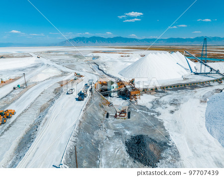 Salt Lake City, Utah landscape with desert salt mining factory at lake Bonneville with piles of white mineral and industrial equipment 97707439
