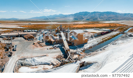 Salt Lake City, Utah landscape with desert salt mining factory at lake Bonneville with piles of white mineral and industrial equipment Salt Lake City, Utah landscape with desert salt mining factory at lake Bonneville with piles of white mineral and industrial equipment 97707492