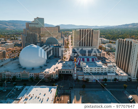 Panoramic aerial view of the city of Reno cityscape in Nevada. Downtown Reno, Nevada, with hotels, casinos and the surrounding High Eastern Sierra foothills. Panoramic aerial view of the city of Reno cityscape in Nevada. Downtown Reno, Nevada, with hotels, casinos and the surrounding High Eastern Sierra foothills. 97707647