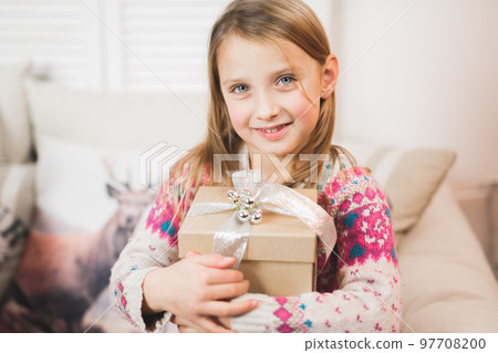 Portrait of cute little beautiful girl with gift box Portrait of cute little beautiful girl with gift box 97708200