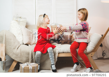 Magic gift box and a child baby girls, Christmas miracle, little beautiful happy smiling girl opens a box with gifts Magic gift box and a child baby girls, Christmas miracle, little beautiful happy smiling girl opens a box with gifts 97708201