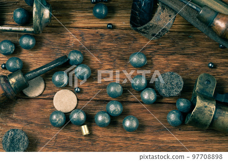 Antique 16 gauge break-action smooth-bored shotgun with brass cases accessories for cartridge reloading. 97708898