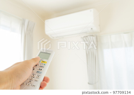 The hand that turns on the air conditioner The hand that turns on the air conditioner 97709134
