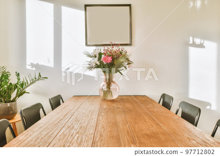 Comfortable sofa with cushions placed against light wall with TV and decorations in modern loving room 97712802