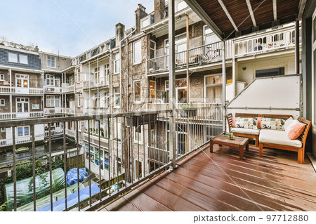 Front view of old buildings from small balcony with railings 97712880