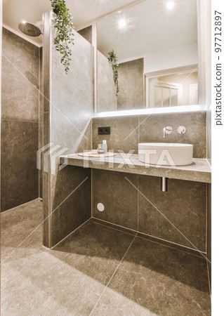 Sinks with mirrors and shower box with glass door in modern bathroom with white tiled walls 97712897