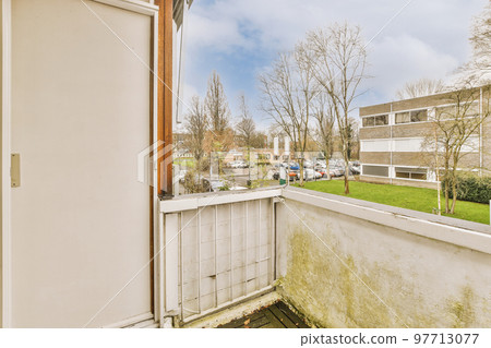 The front view of buildings with pavement and vegetation describing countryside 97713077