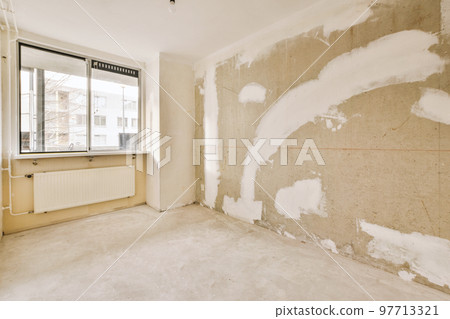 Plastic window and radiator on white wall in empty light room at home Plastic window and radiator on white wall in empty light room at home 97713321