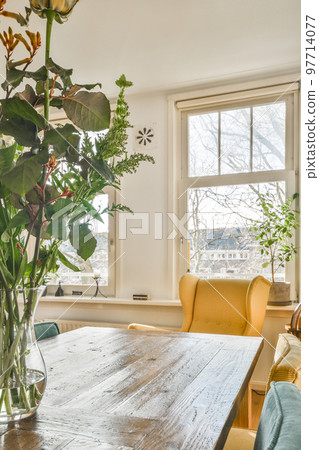 Couches and table located near TV against dining area of spacious room in contemporary apartment 97714077