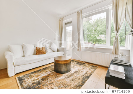 Contemporary minimalist style interior design of light studio apartment with wooden table and chairs in dining zone between open kitchen and living room with white walls and parquet floor Contemporary minimalist style interior design of light studio apartment with wooden table and chairs in dining zone between open kitchen and living room with white walls and parquet floor 97714109