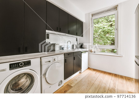 Interior of modern bright laundry room with white walls and dark reflect floor 97714136