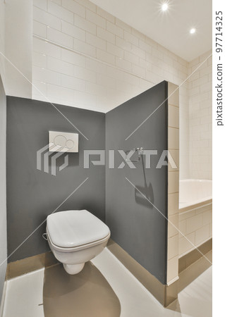 Interior of modern bathroom with bathtub and sink in wooden counter furnished with wooden shelf rack 97714325