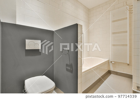 Interior of modern bathroom with bathtub and sink in wooden counter furnished with wooden shelf rack Interior of modern bathroom with bathtub and sink in wooden counter furnished with wooden shelf rack 97714339