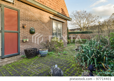 Neat patio with sNeat paved patio with sitting area and small garden near wooden fenceitting area 97714401