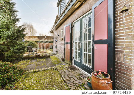 Neat patio with sNeat paved patio with sitting area and small garden near wooden fenceitting area 97714429