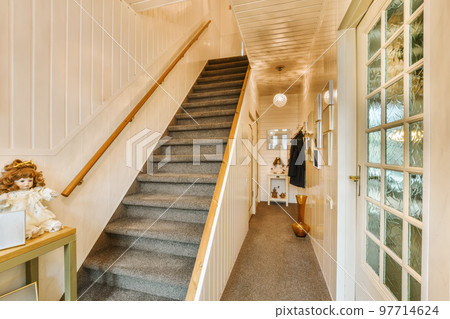 a staircase leading up to the second floor in a house with white painted walls and wood trim on the stairs a staircase leading up to the second floor in a house with white painted walls and wood trim on the stairs 97714624