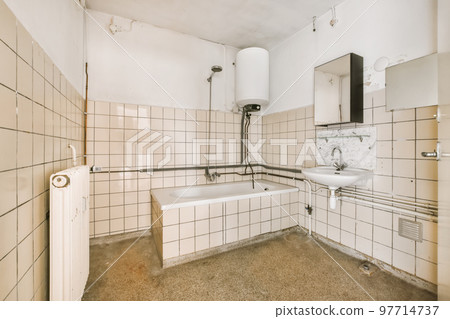 a bathroom with white tiles on the walls, and a bathtub in the corner next to the shower stall 97714737