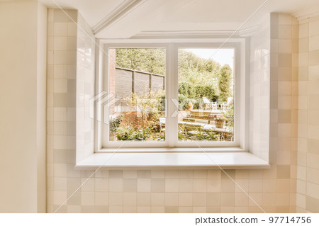 a bathroom window with the view out to the garden from it's bathtub in front of the house 97714756