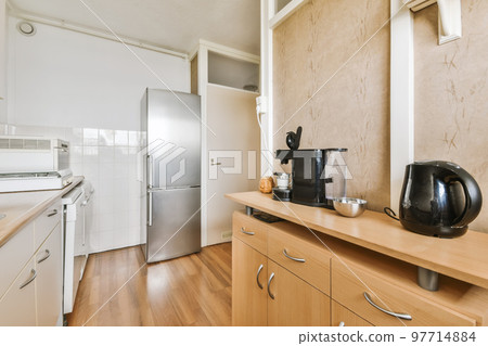 a kitchen with wood flooring and white appliances on the counter top in this photo is taken from the inside 97714884