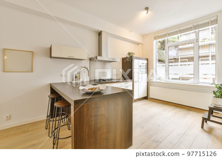 a kitchen and dining area in a house with white walls, hardwood flooring and large windows overlooking out onto the street 97715126
