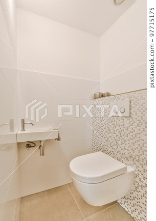 a bathroom with white tiles on the wall and toilet in the corner, there is a sink next to it a bathroom with white tiles on the wall and toilet in the corner, there is a sink next to it 97715175
