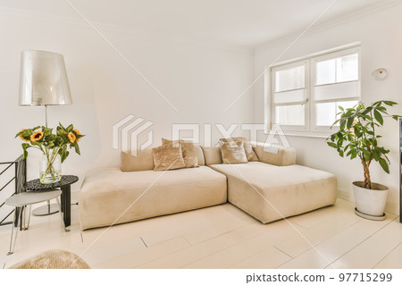 a living room with two couches and flowers in vases on the coffee table next to the sofa is white 97715299