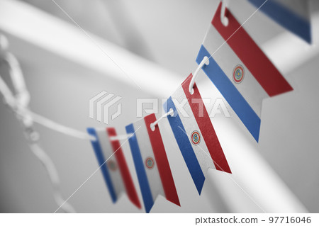 A garland of Paraguay national flags on an abstract blurred background A garland of Paraguay national flags on an abstract blurred background 97716046