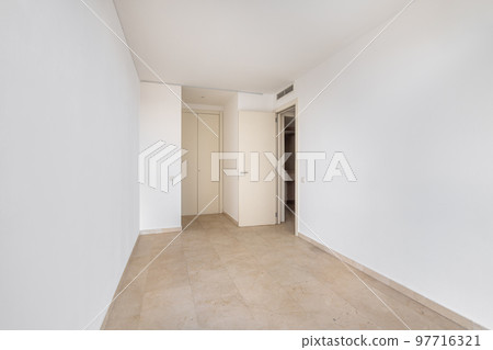 Empty room with tile flooring and newly painted white walls. Repair and construction concept. 97716321