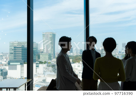 People silhouettes in the office building People silhouettes in the office building 97716390