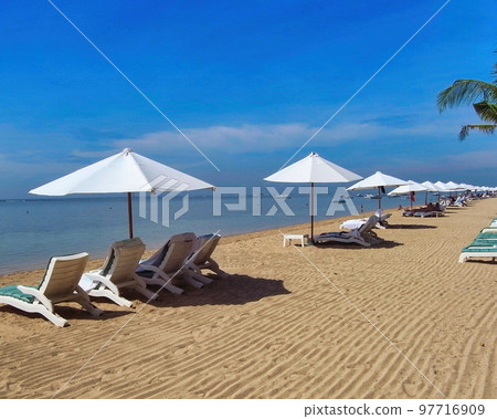 white umbrellas on sanur beach 97716909