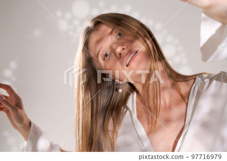 Seductive woman portrait. Posing in background with light unusual shadows airy Seductive woman portrait. Posing in background with light unusual shadows airy 97716979