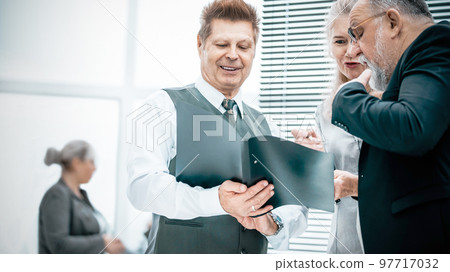 close up. experienced company employees discussing business documents close up. experienced company employees discussing business documents 97717032