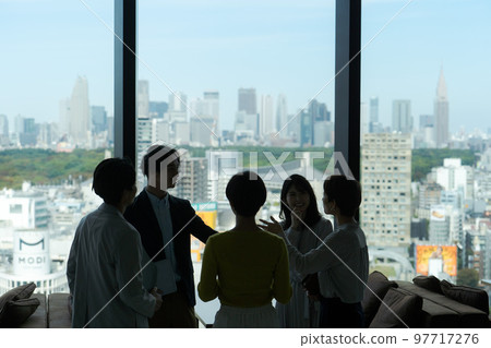 Shadows of people discussing in an office building Shadows of people discussing in an office building 97717276