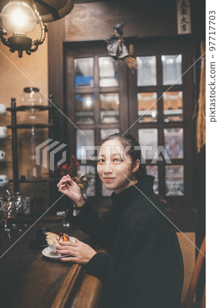 A woman taking a break at a coffee shop A woman taking a break at a coffee shop 97717703