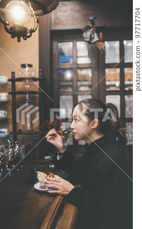 A woman taking a break at a coffee shop A woman taking a break at a coffee shop 97717704
