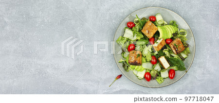Salad of frying tofu and fresh vegetables. 97718047