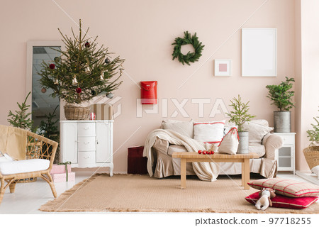 Cozy sofa standing in a stylish room, beautifully decorated for the celebration of Christmas and New Year Cozy sofa standing in a stylish room, beautifully decorated for the celebration of Christmas and New Year 97718255