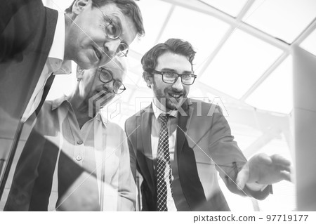 close up. business lady and her colleagues standing near the office Desk. close up. business lady and her colleagues standing near the office Desk. 97719177