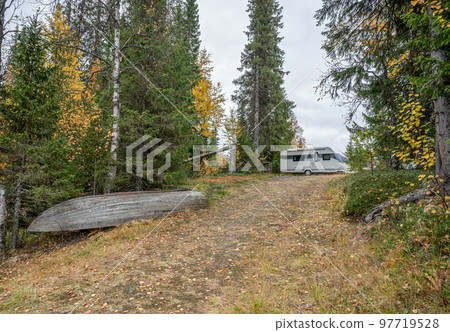 camping caravan near river autumn fall landscape along Ammarnas National Park in Lapland Sweden 97719528