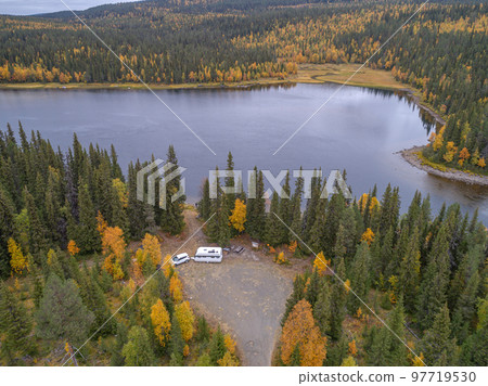 aerial view camping caravan near river autumn fall landscape along Ammarnas National Park in Lapland Sweden 97719530