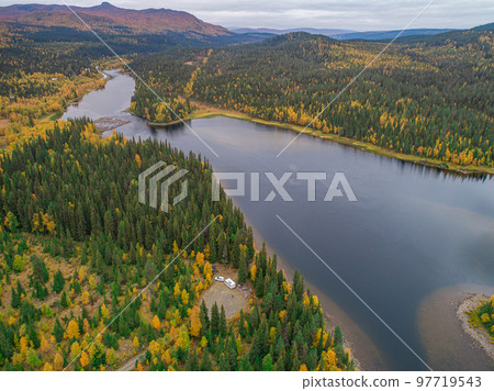 aerial view camping caravan near river autumn fall landscape along Ammarnas National Park in Lapland Sweden aerial view camping caravan near river autumn fall landscape along Ammarnas National Park in Lapland Sweden 97719543