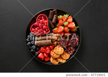 Charcuterie Valentines Day charcuterie board with chocolate sweets. Charcuterie Valentines Day charcuterie board with chocolate sweets. 97719931