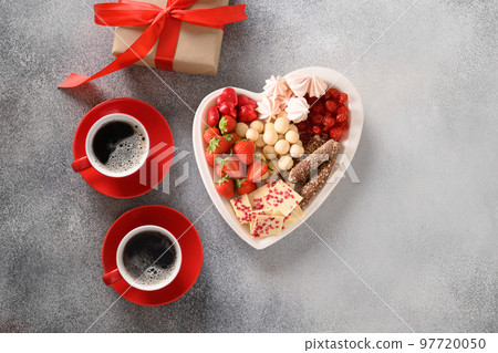 Charcuterie Valentines Day board with coffee and chocolate sweets. Charcuterie Valentines Day board with coffee and chocolate sweets. 97720050