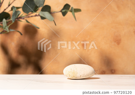Natural empty background for cosmetic product presenation, packaging mockup made with stone and eucalyptus. Minimal nature scene. Front view, copy space. Natural empty background for cosmetic product presenation, packaging mockup made with stone and eucalyptus. Minimal nature scene. Front view, copy space. 97720120