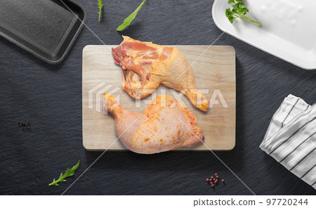 Chicken thighs on a flat lay of a kitchen with various items 97720244