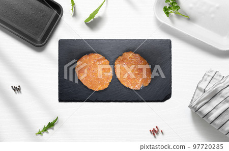 Chicken hamburguer on a flat lay of a kitchen with various items Chicken hamburguer on a flat lay of a kitchen with various items 97720285