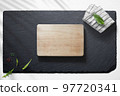 Empty cutting board with various food items 97720341