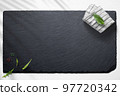 Empty slate board on a flat lay of a kitchen with various items 97720342