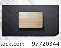 Cutting board against a slate plate 97720344